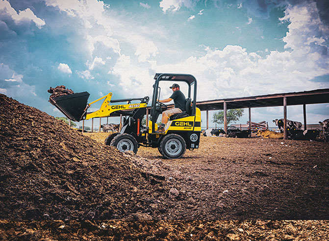 Articulated loader lifting dirt